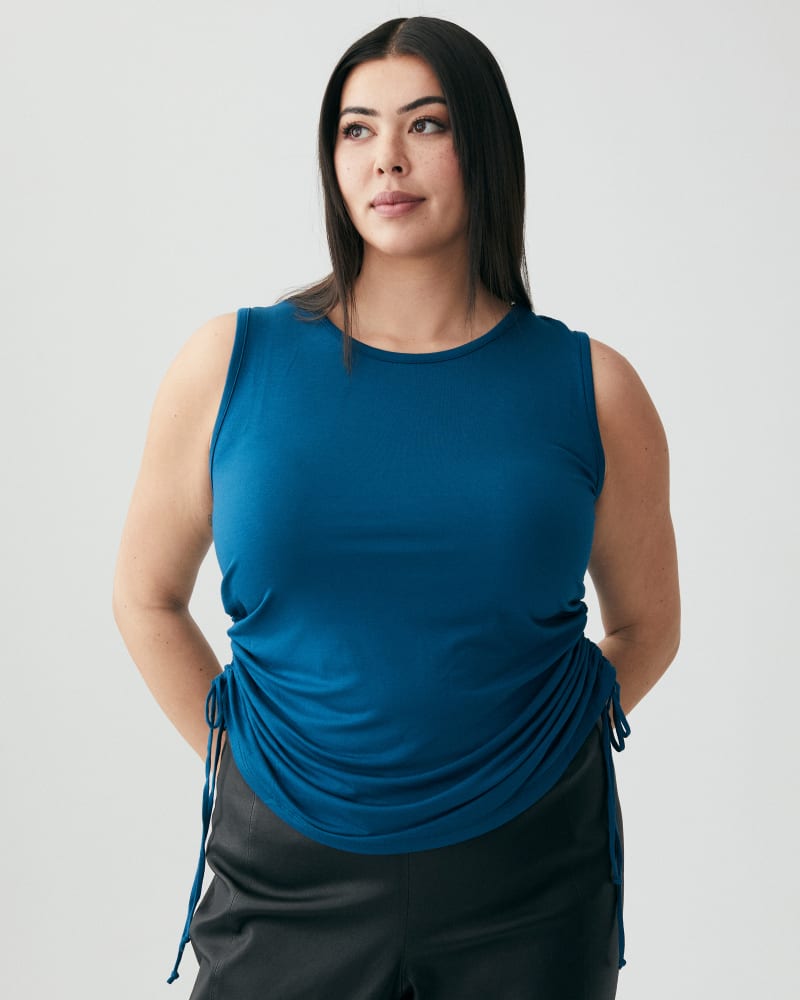 Front of a model wearing a size 1X Eloise Drawstring Tank Top in Teal by Socialite. | dia_product_style_image_id:271381